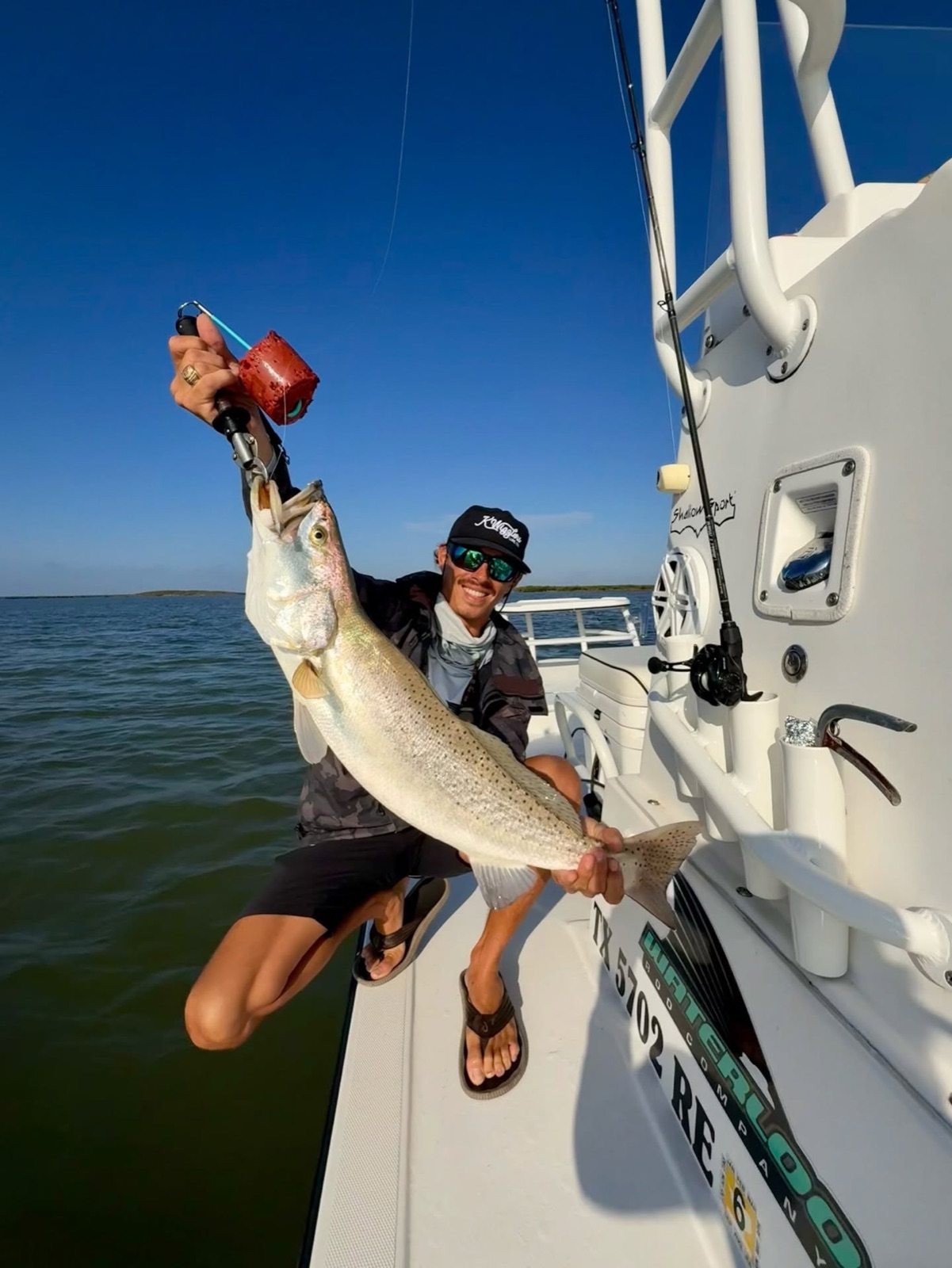 Speckled trout held up on the boat deck