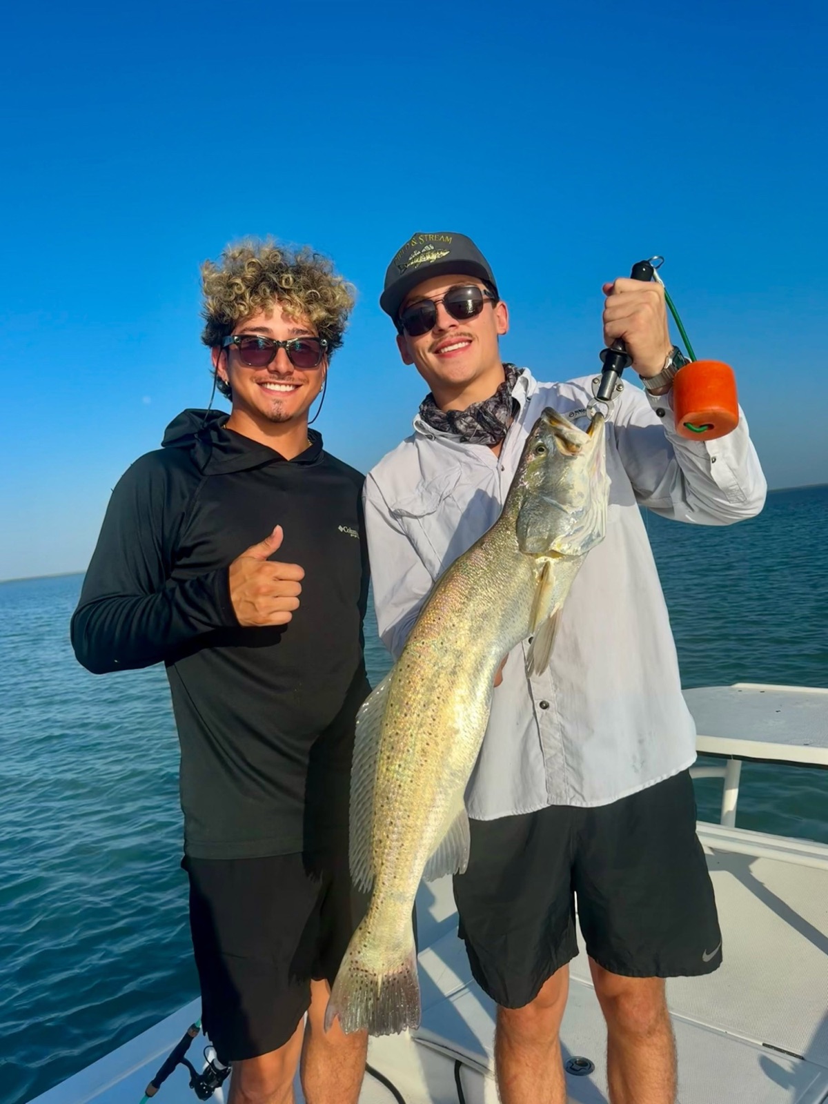 Two anglers with a big speckled trout