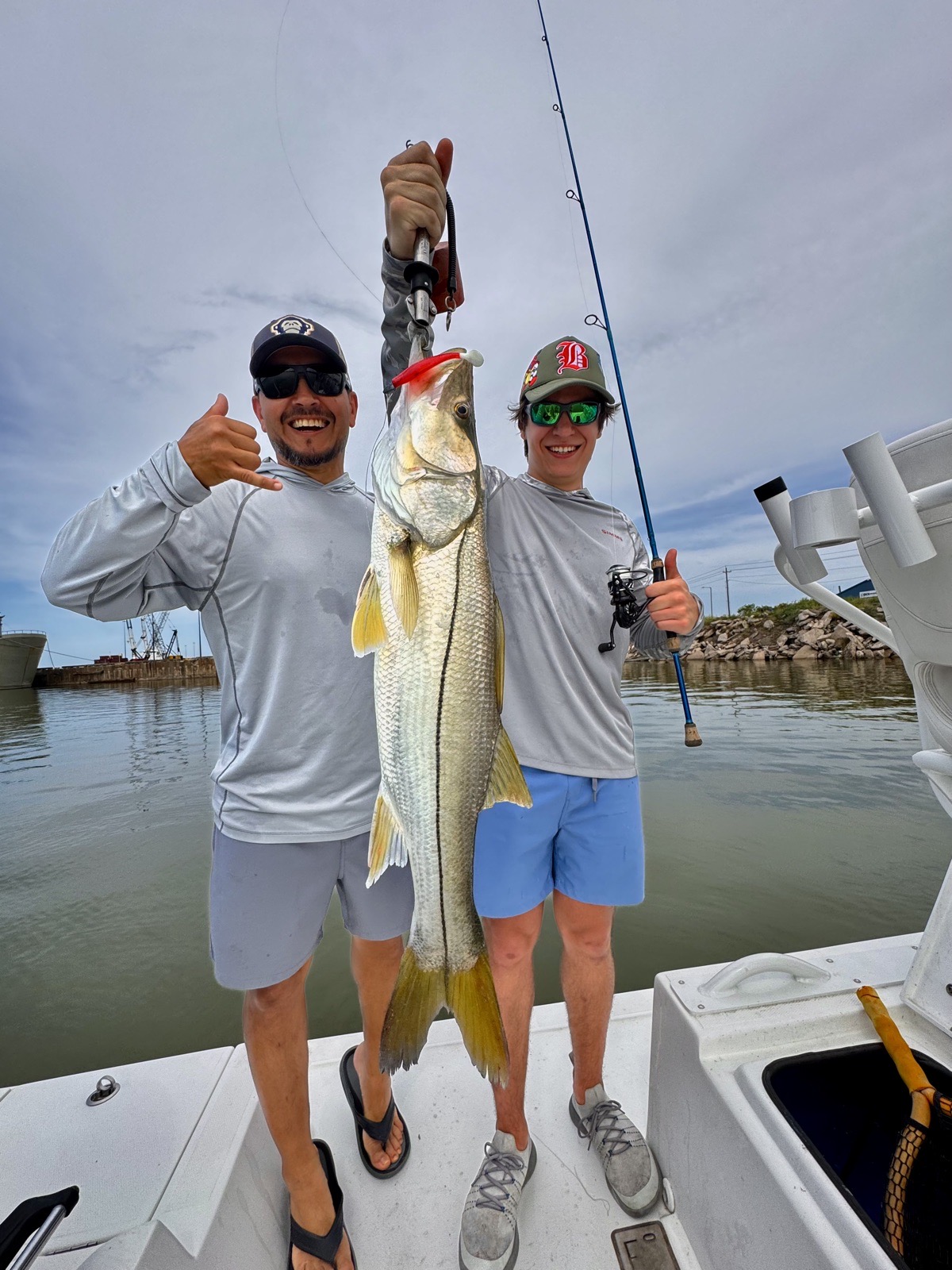 Two anglers with a big snook on the bow