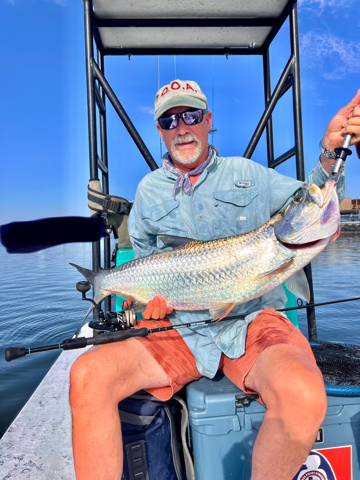 Angler seated on the boat with a tarpon