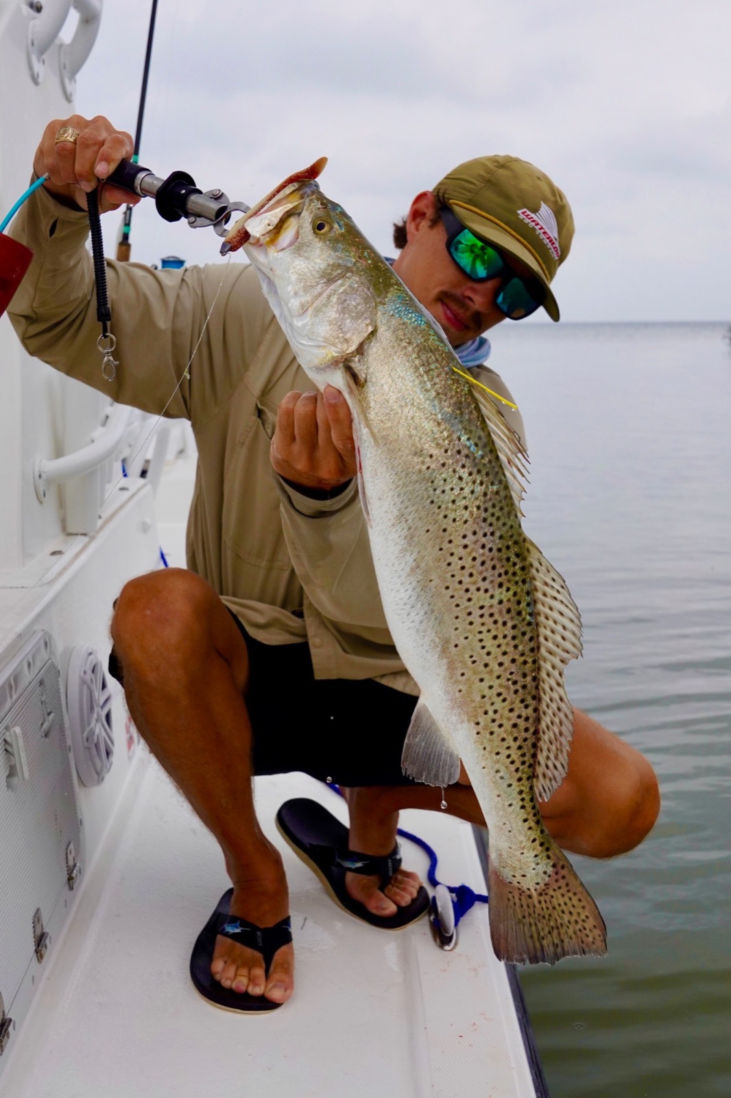 Capt. Trevor Kucia with a big speckled trout on the boat