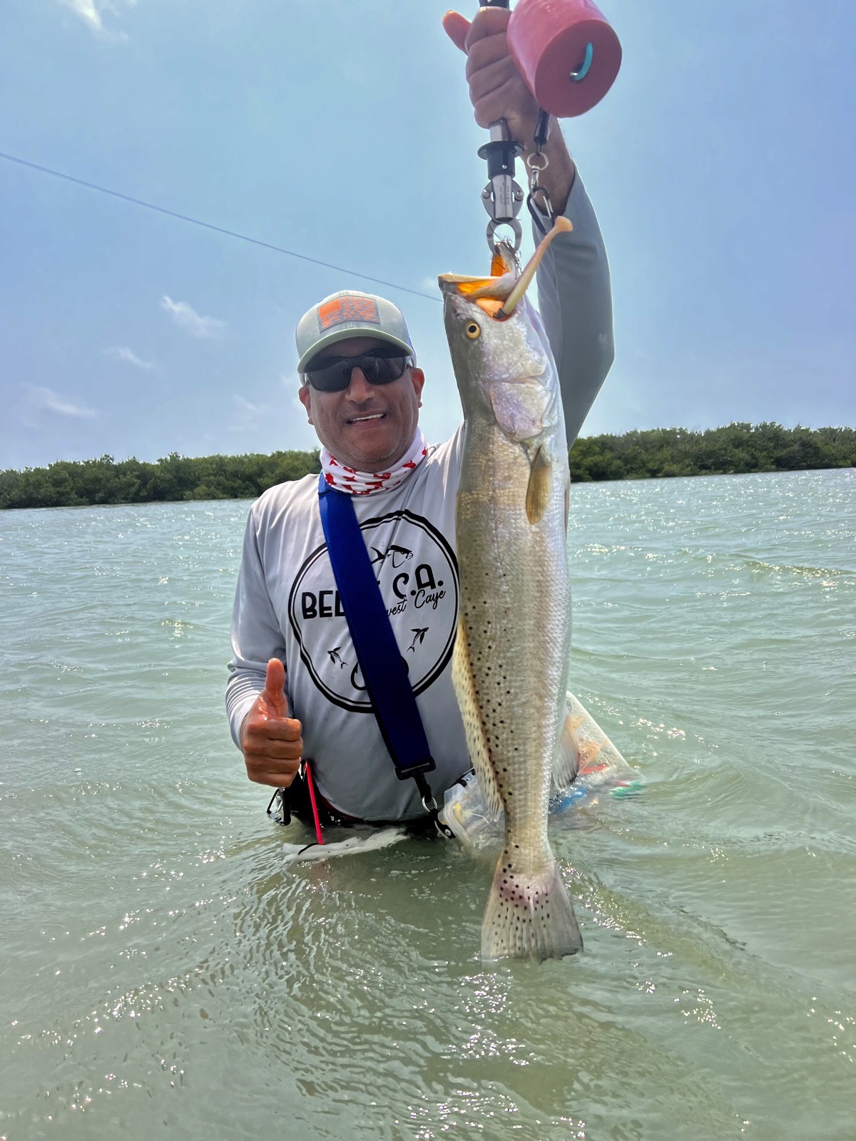 Angler wading with a speckled trout