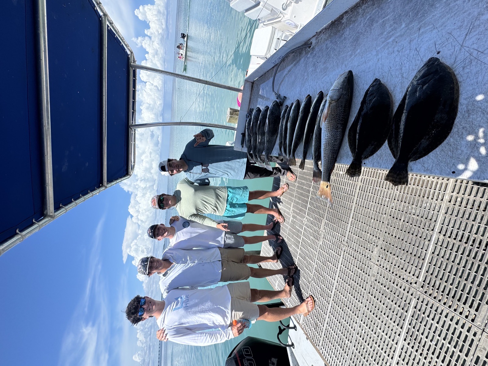 Group of anglers with a catch of black drum and redfish